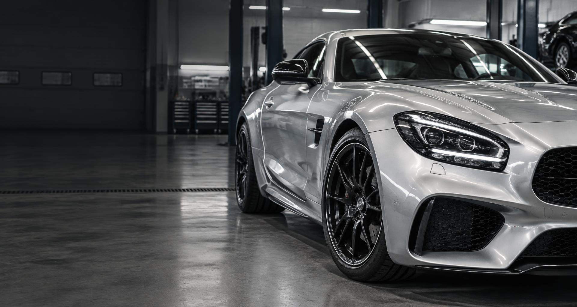 Silver sports coupe with a pristine paint finish in an automotive workshop